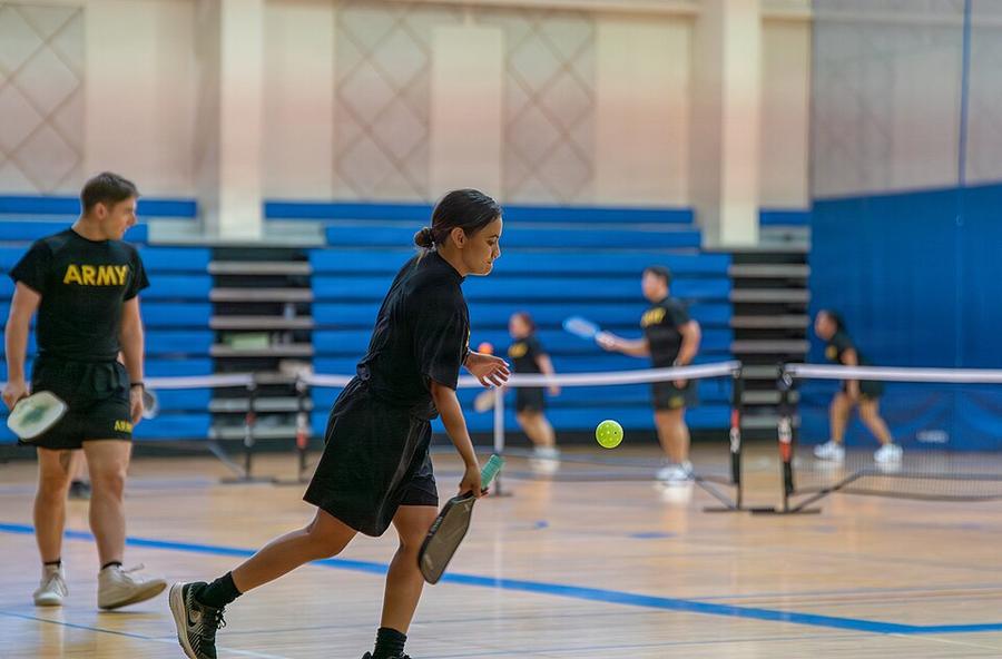 A player returning a volley during a preliminary tournament match